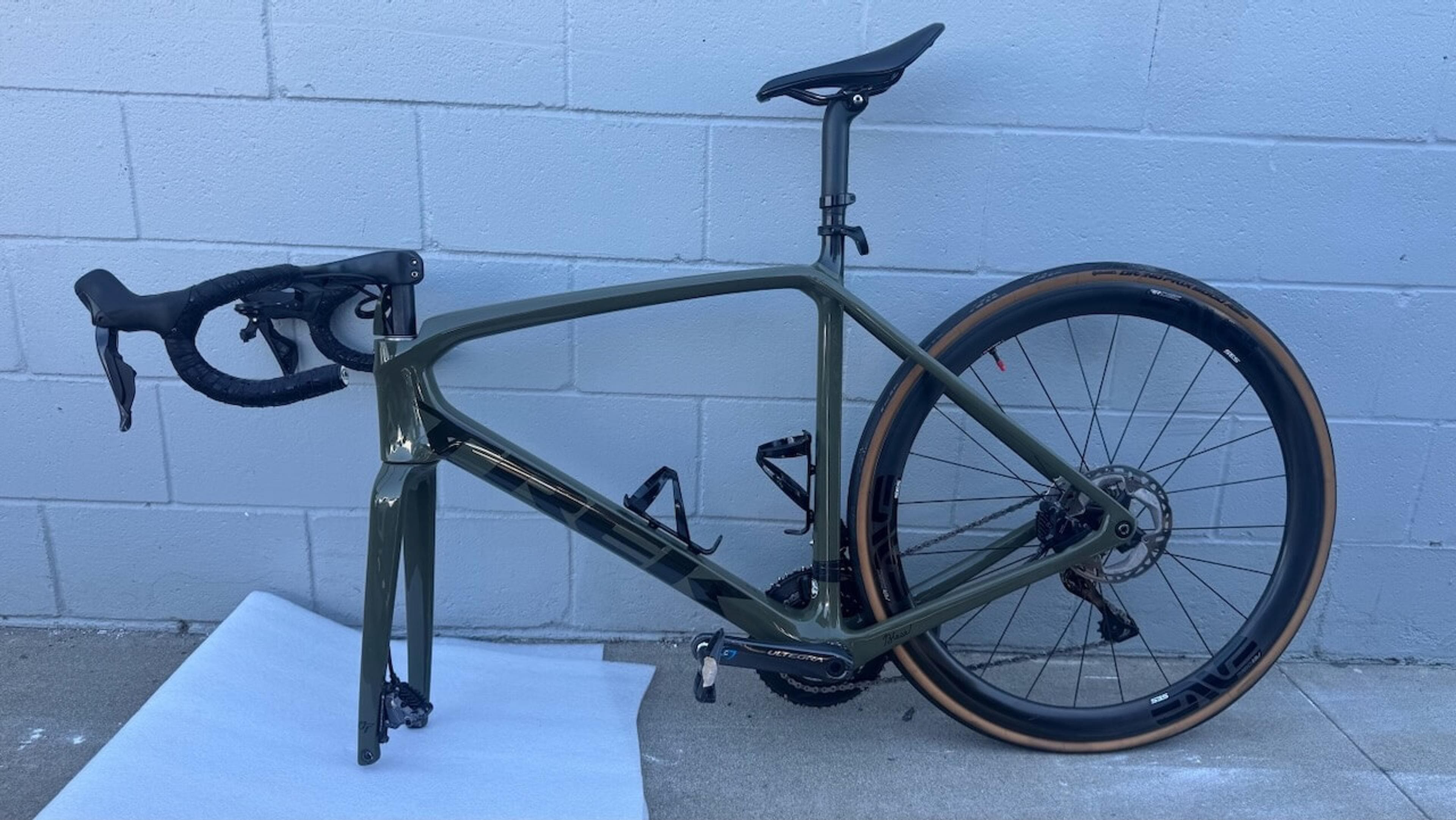 Close-up of the restored Trek Émonda SL top tube after carbon fiber repair and refinishing