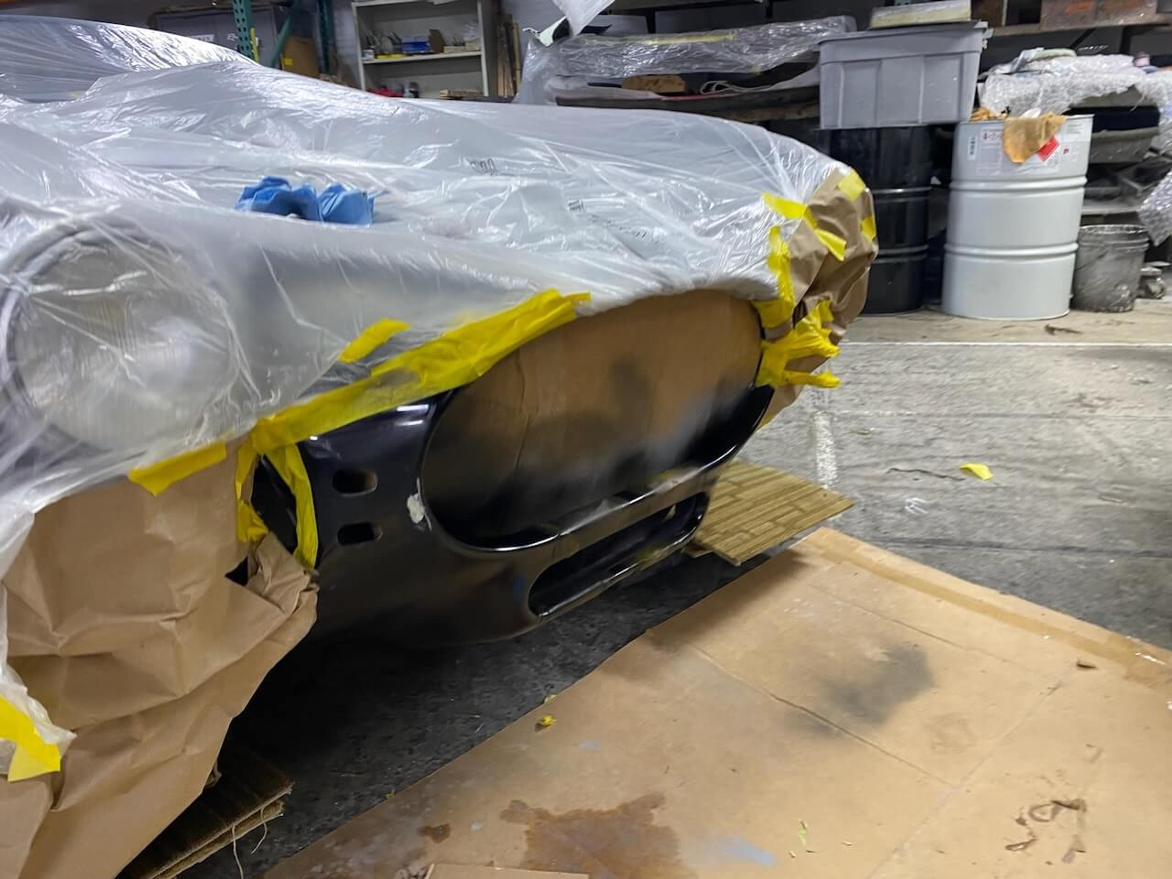 Shelby Cobra-style roadster with the repaired front fiberglass body section masked and prepared for refinishing.
