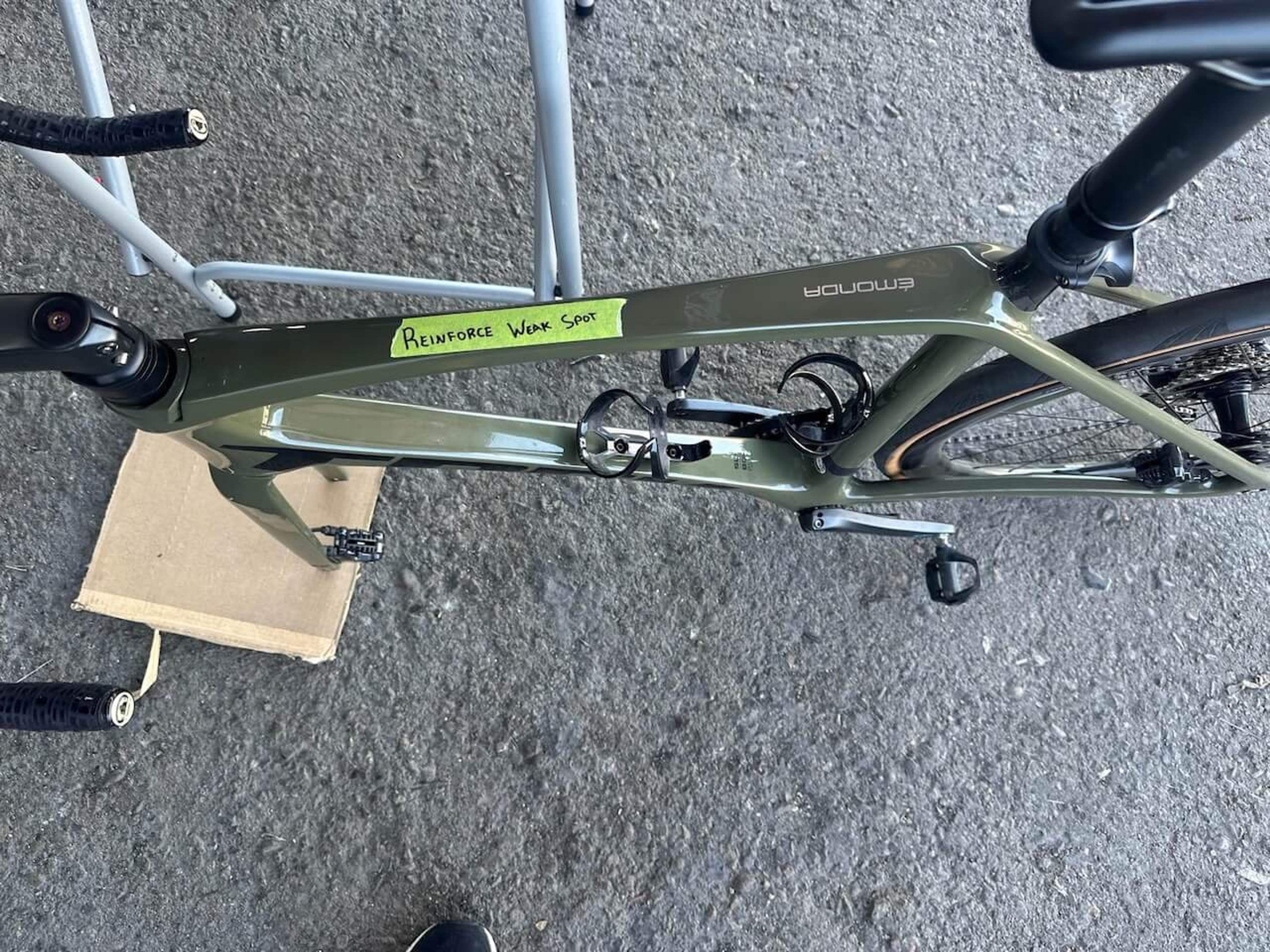 Close-up of the damaged top tube area on a Trek Émonda SL carbon fiber frame before repair