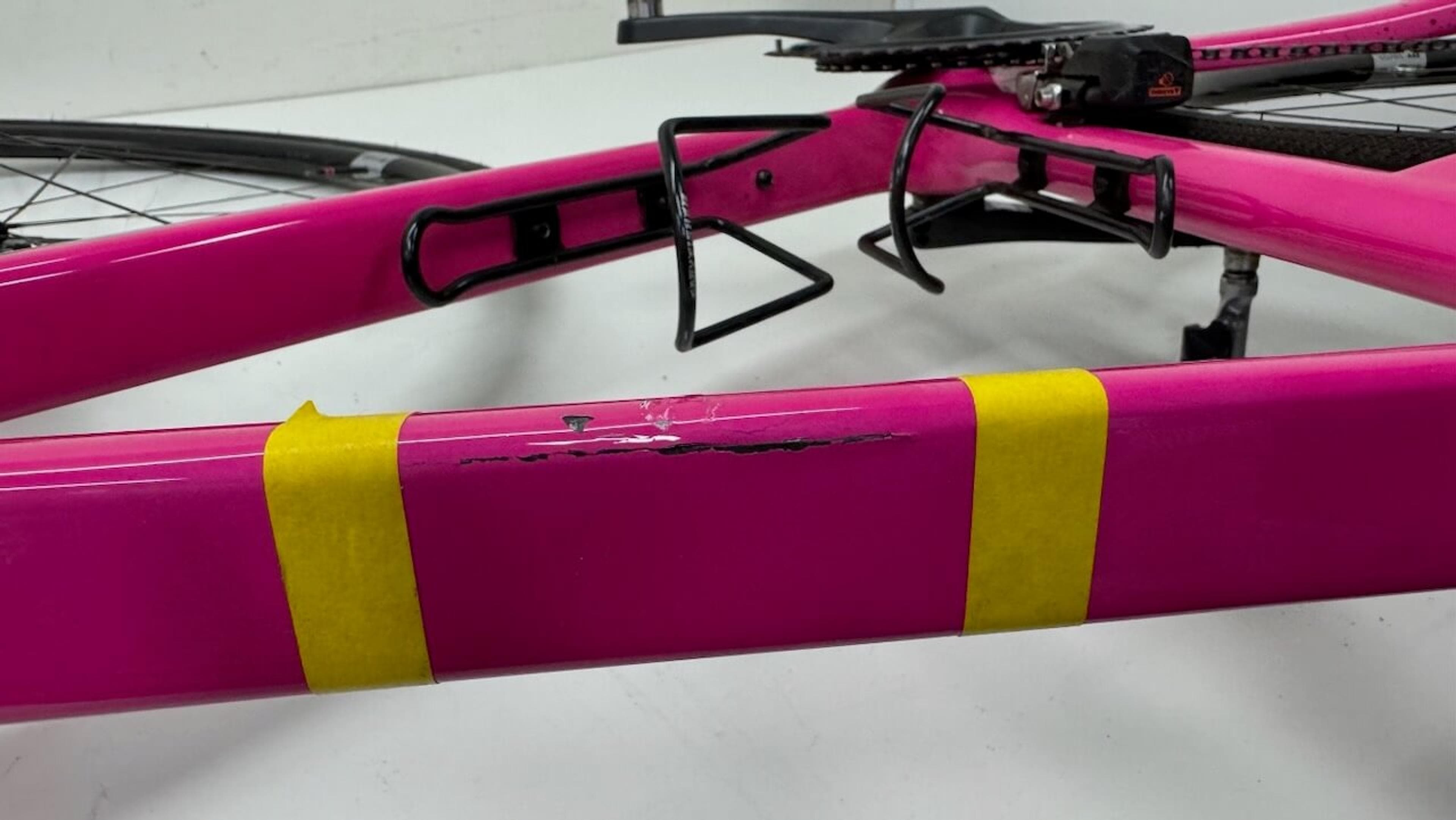 Side view of cracked Quintana Roo SRfive top tube marked with masking tape