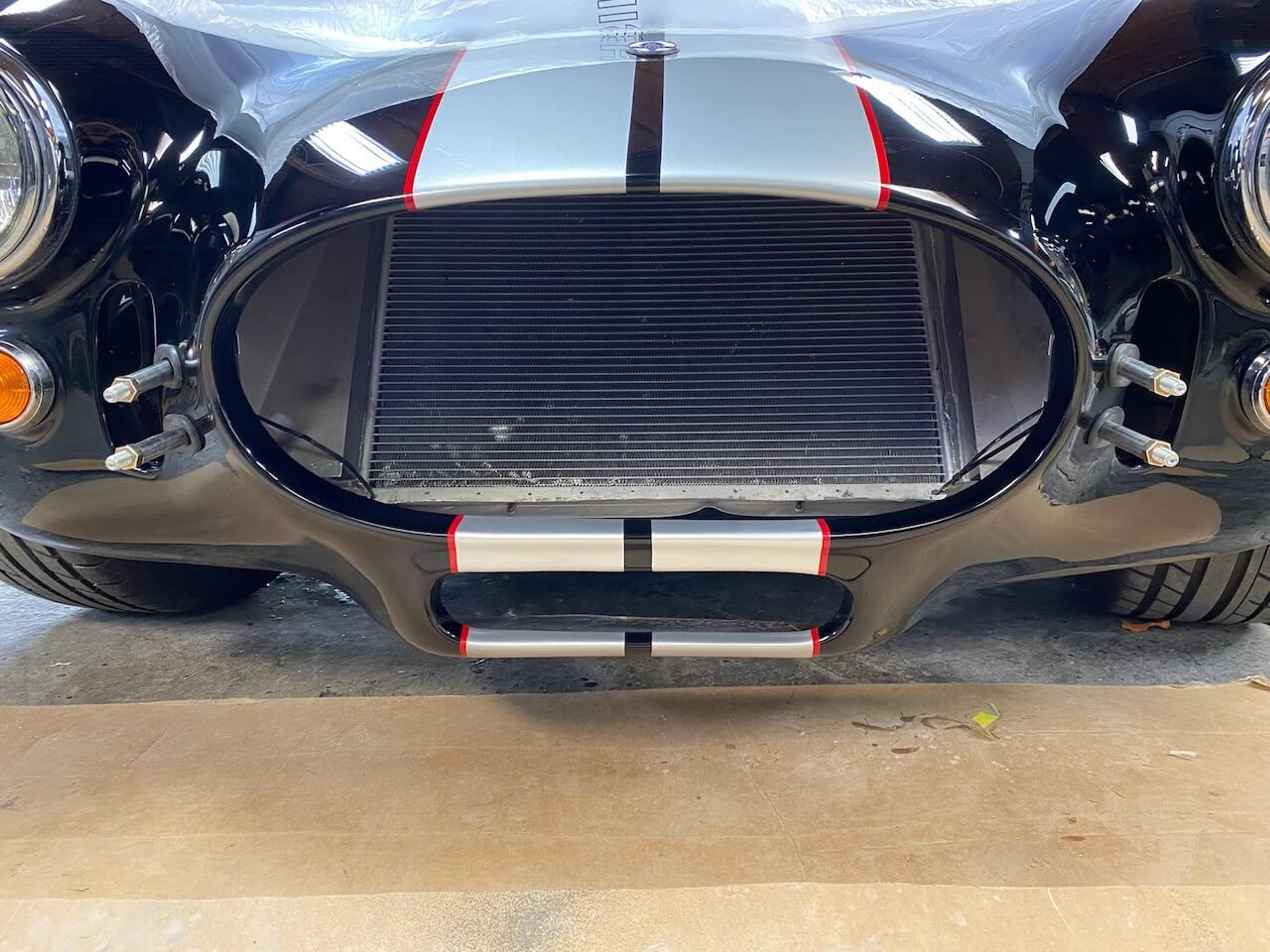 Front view showing the repaired and refinished lower valance on a Shelby Cobra-style roadster