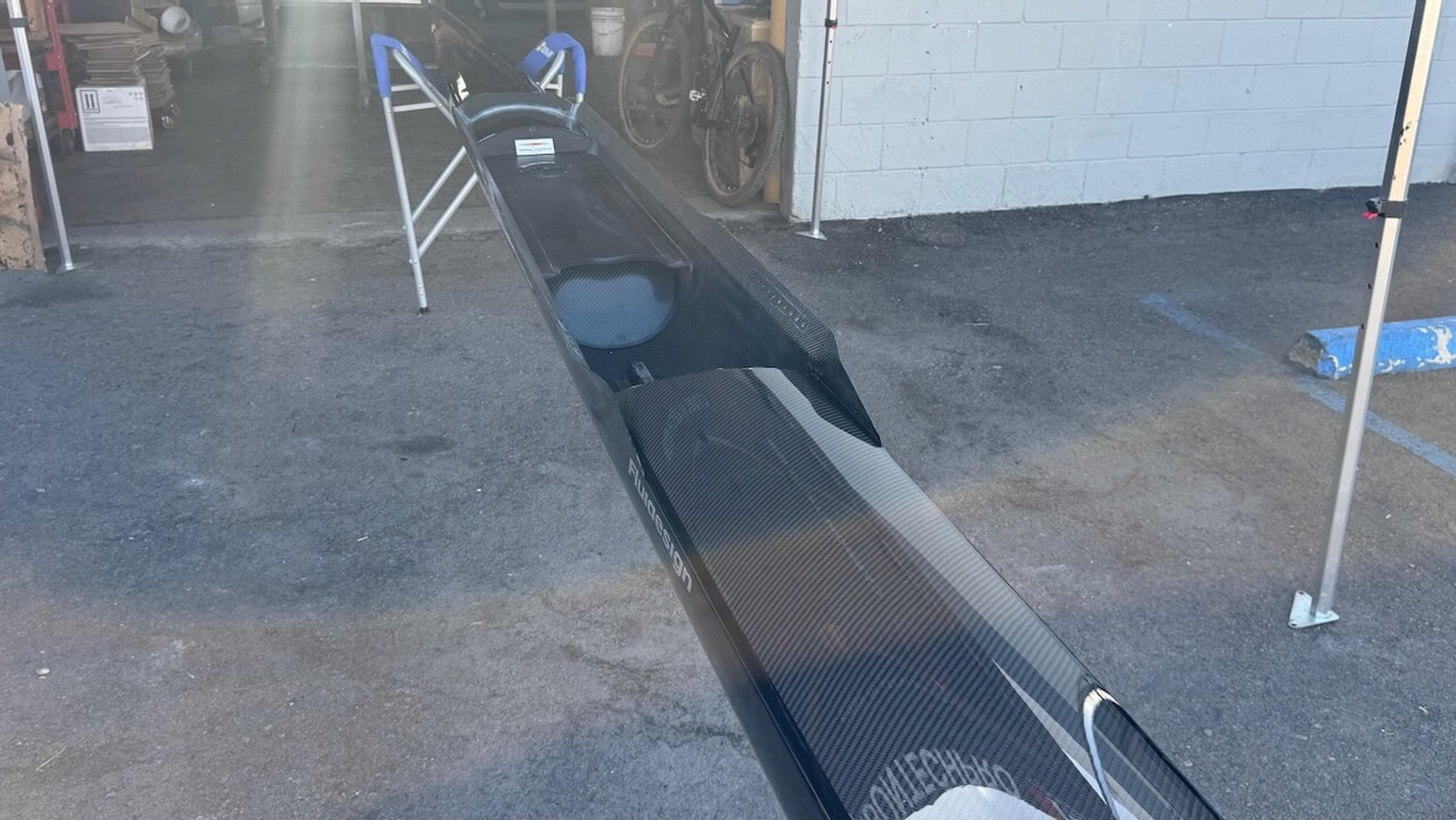 Wide interior view of a repaired Fluidesign carbon fiber rowing shell