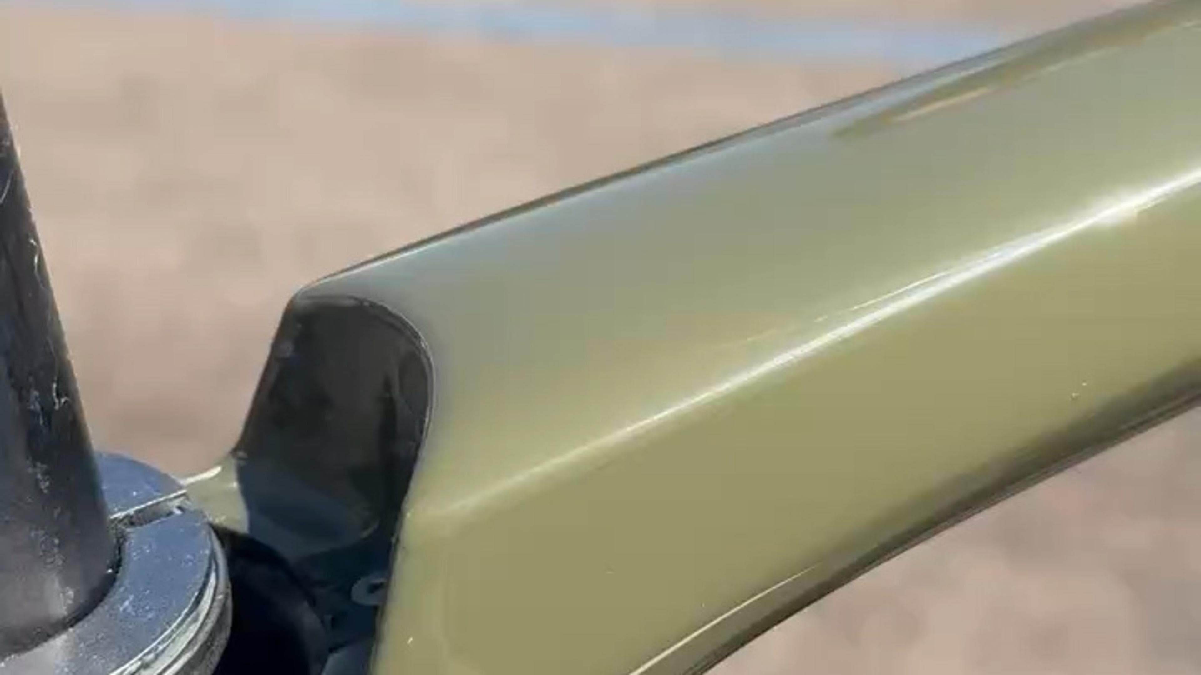 Close-up video showing the repaired top tube and refinished carbon fiber frame on a Trek Émonda SL road bike.