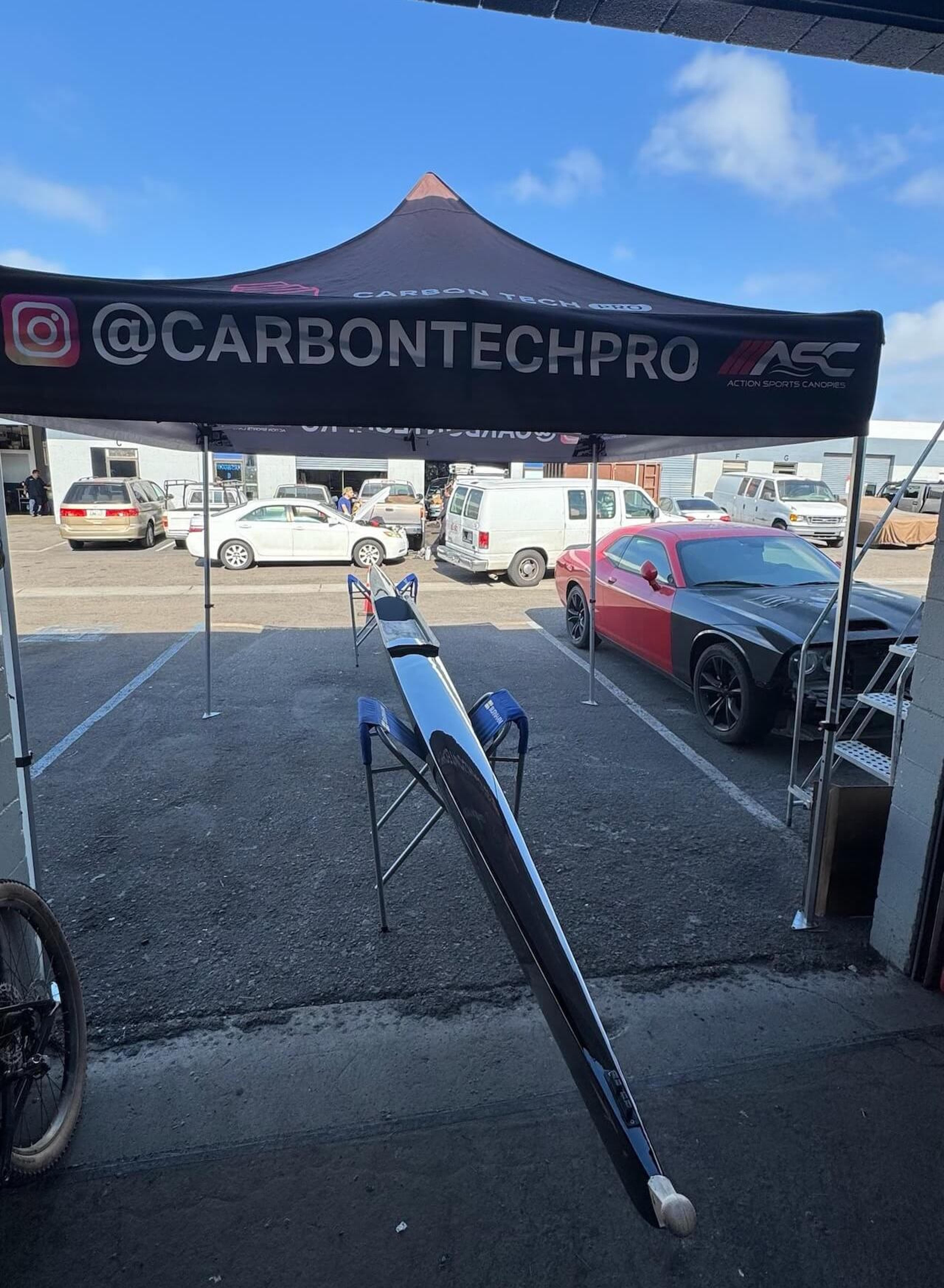Full-length Fluidesign carbon fiber rowing shell after repair outside Carbon Tech Pro