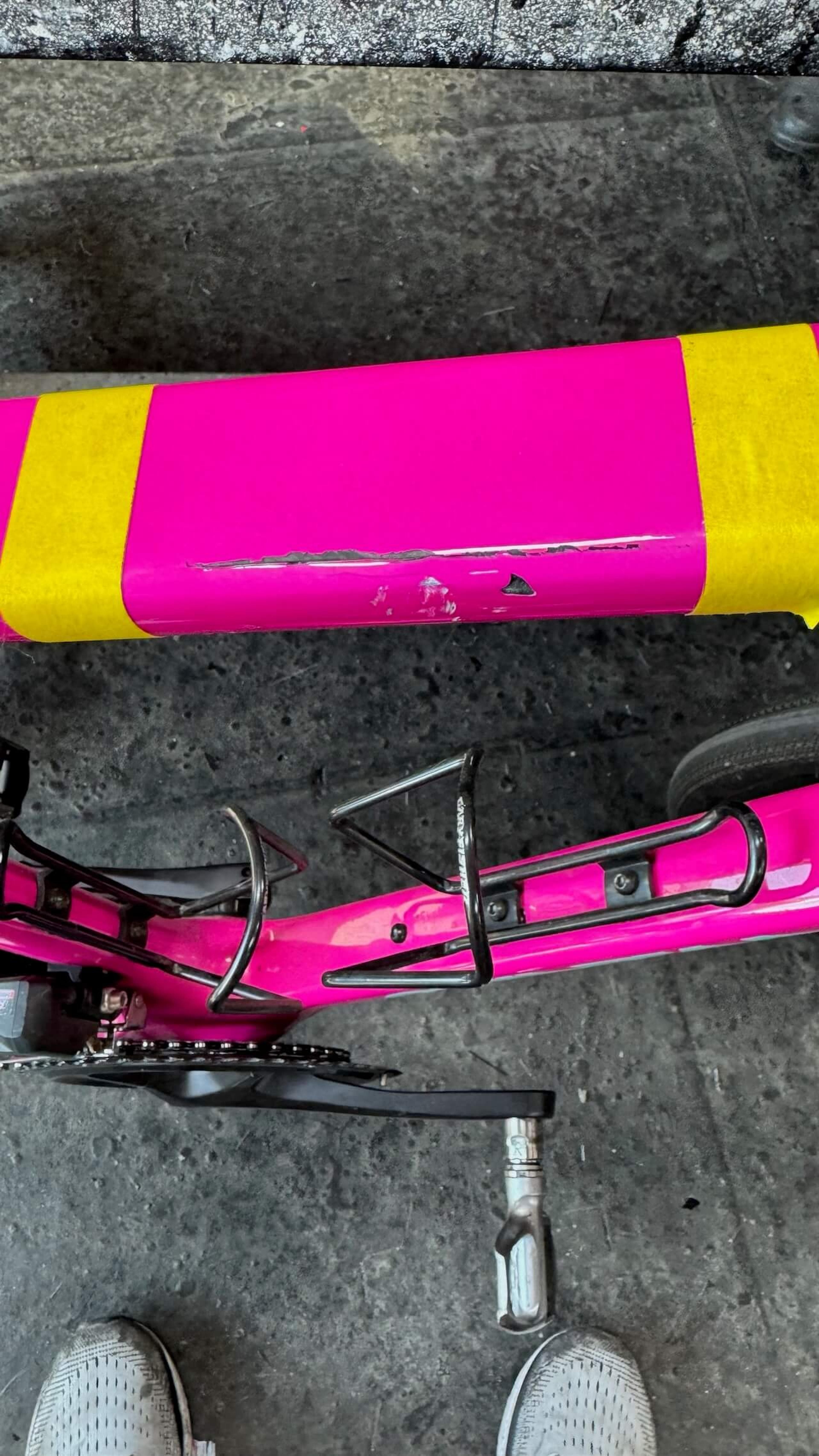 Close-up of damaged top tube on pink Quintana Roo SRfive carbon fiber road bike