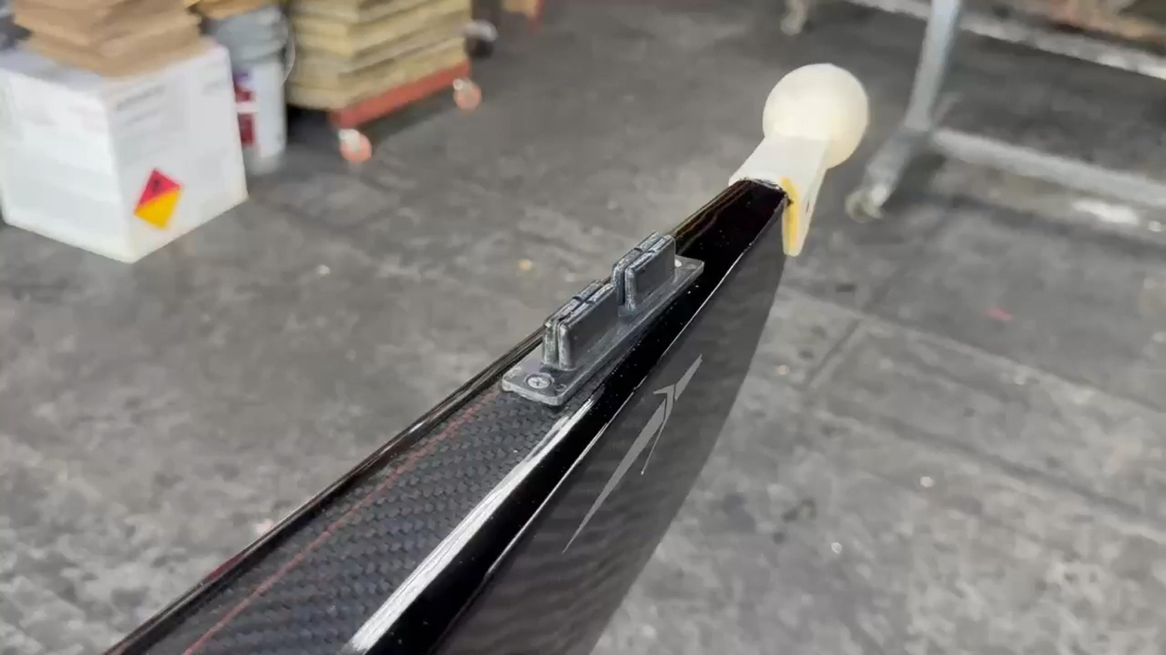 End-to-end video showing the restored carbon fiber finish of a Fluidesign high-performance rowing shell after repair.