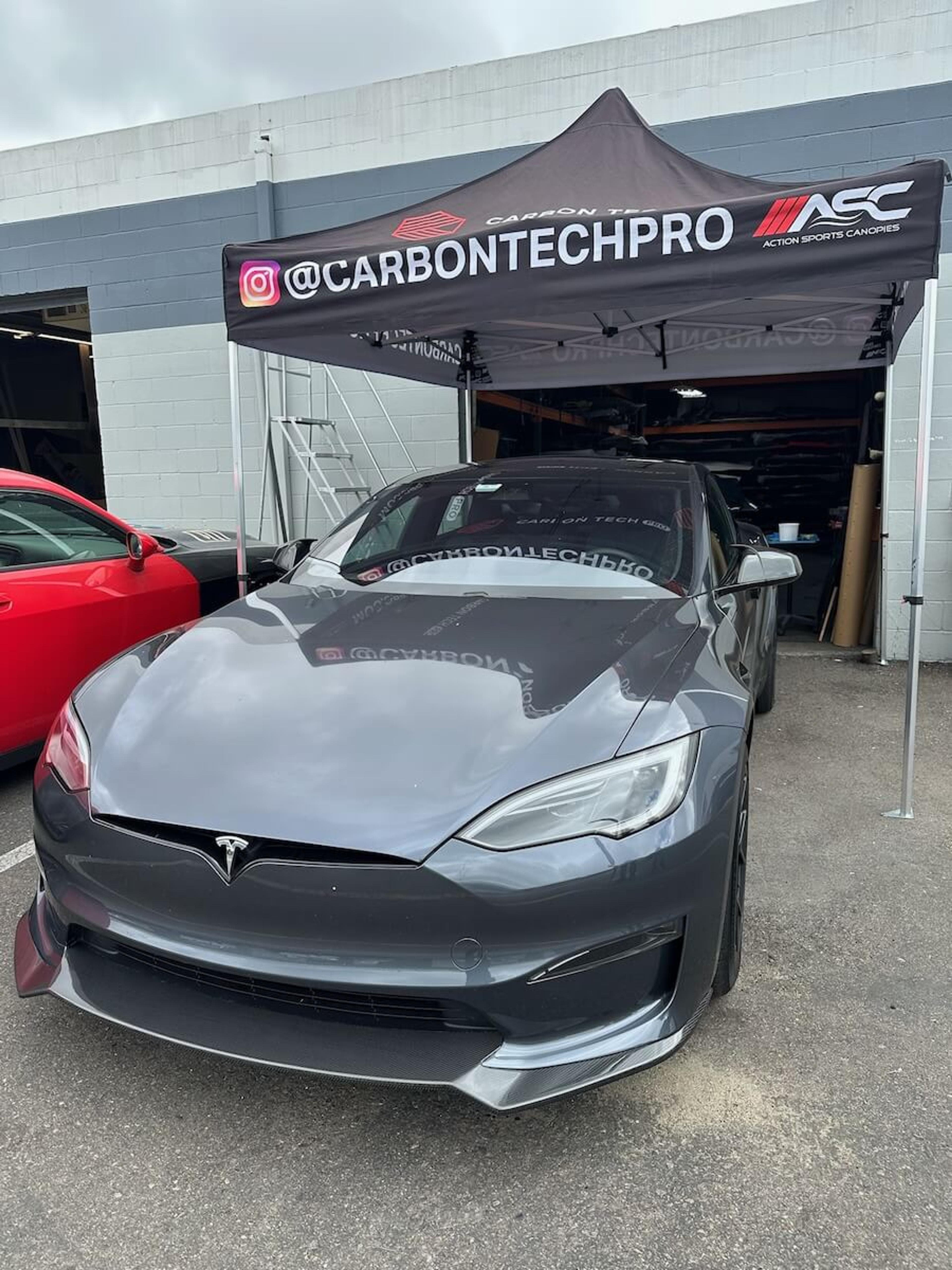 Front three-quarter view of Tesla Model Y with carbon fiber front lip installed