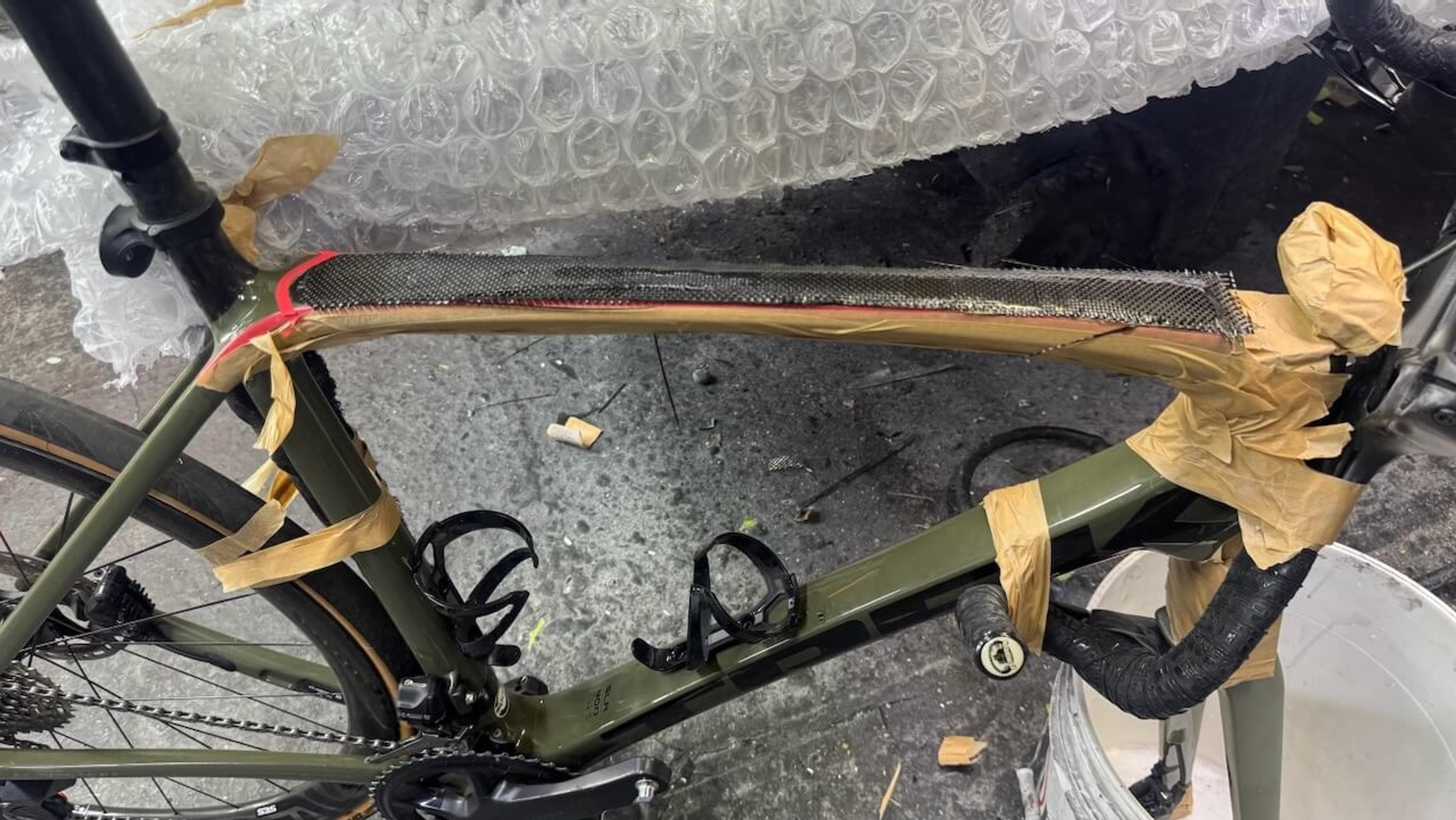 Wider view of the reinforced top tube on a Trek Émonda SL carbon fiber frame during repair