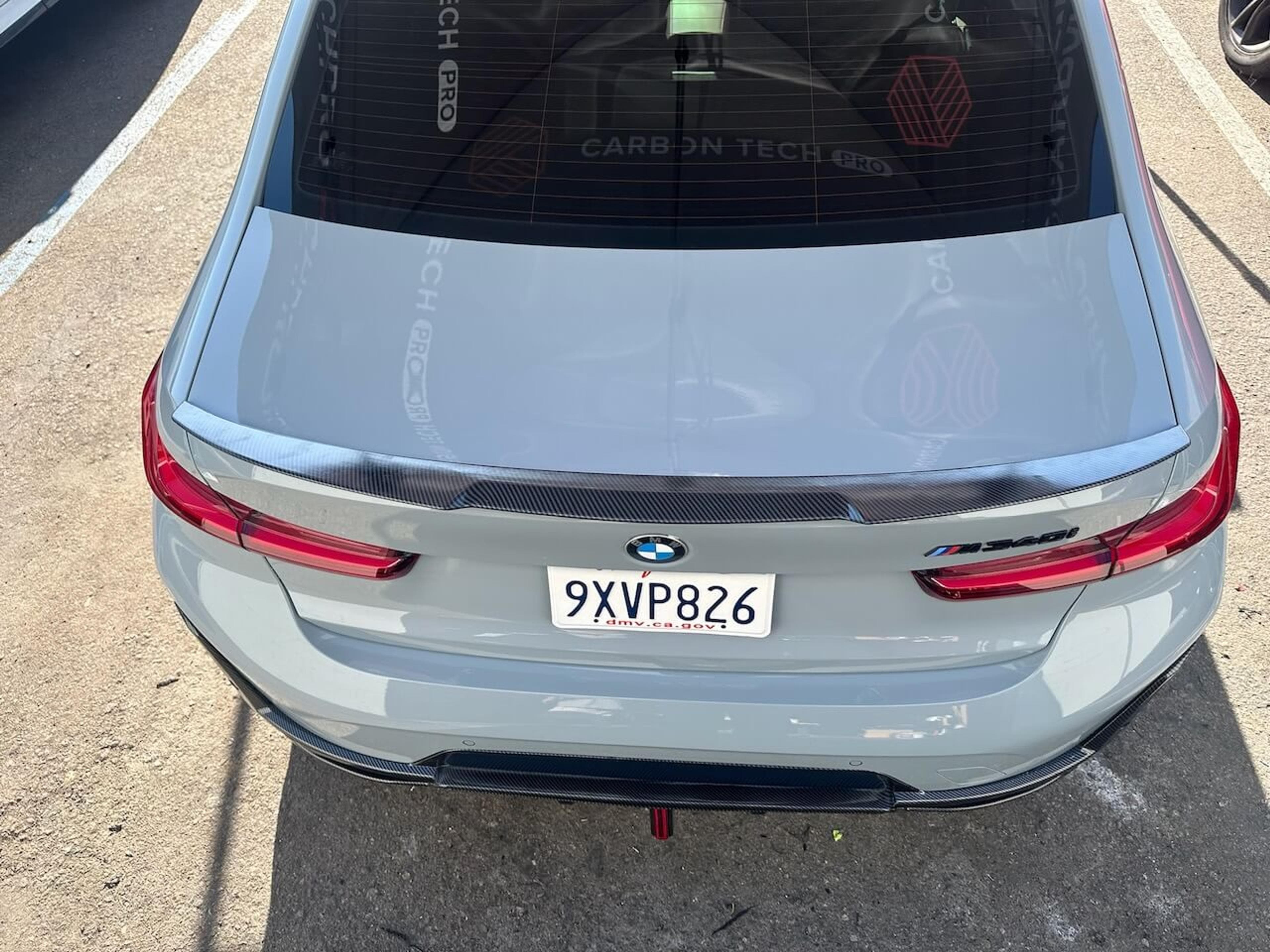 Overhead rear view of a BMW M340i showing the installed carbon fiber trunk spoiler