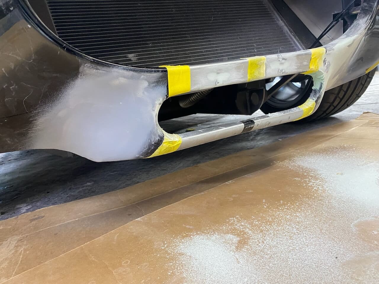Front lower body of a Shelby Cobra-style roadster sanded and reshaped during fiberglass repair