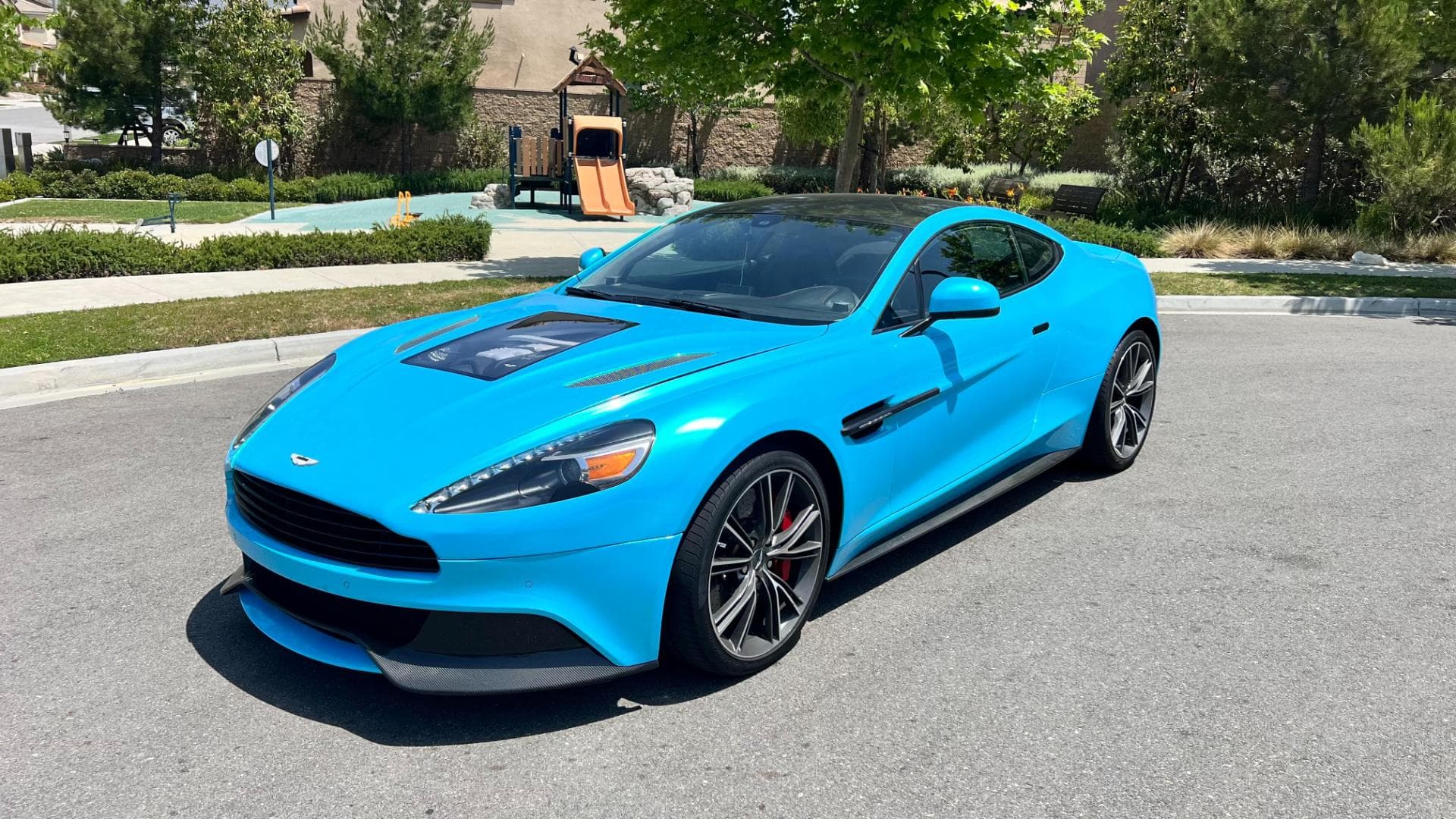 Aston Martin Vanquish Coupe Blue Aston Martin Vanquish Coupe at the end of a street